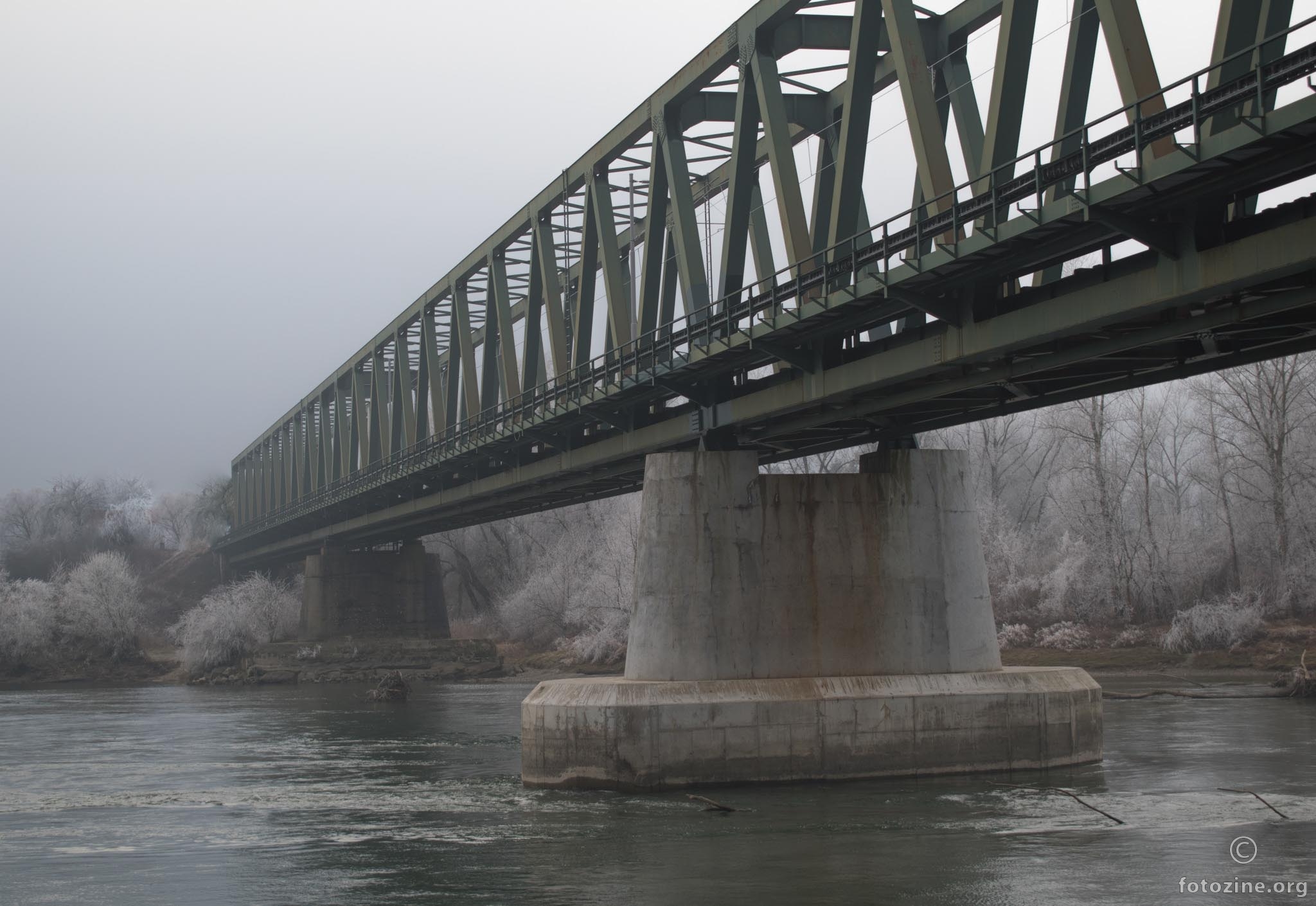 Bridge over river in winter